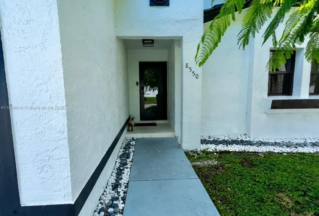 a view of a pathway of a house with a yard
