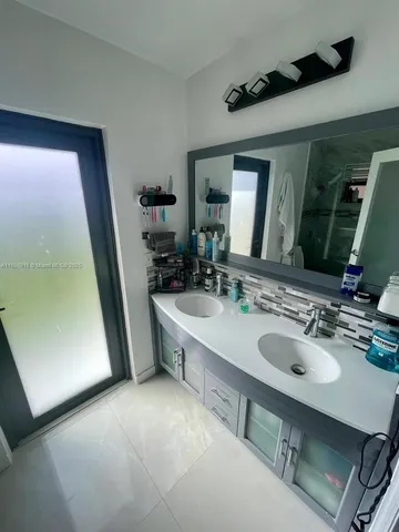 a bathroom with a sink a mirror and a bathtub