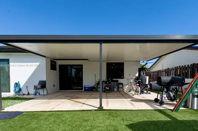 a view of a patio with table and chairs