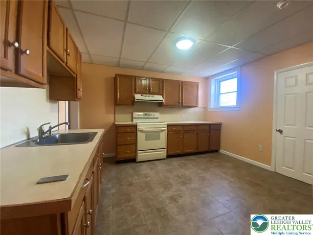 a kitchen with a sink stove and cabinets