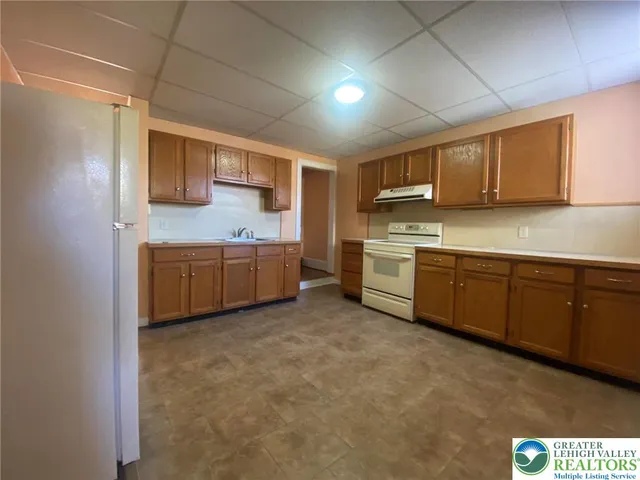 a kitchen with stainless steel appliances granite countertop a sink and cabinets