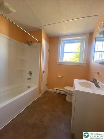 a bathroom with a bathtub and a sink