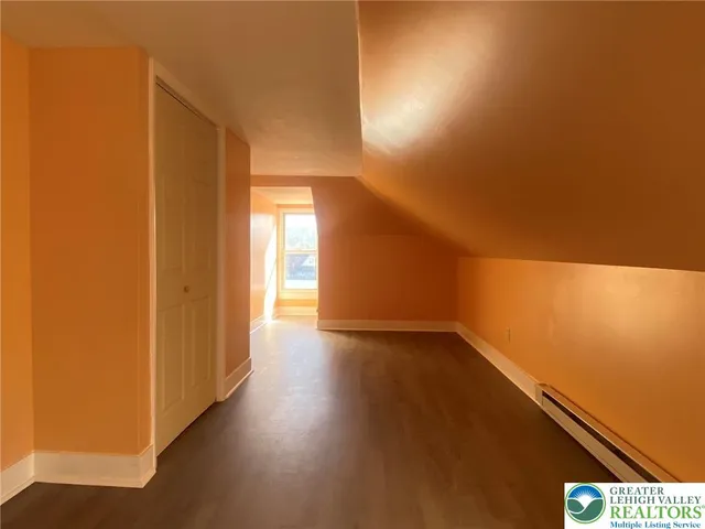 a view of an empty room and wooden floor