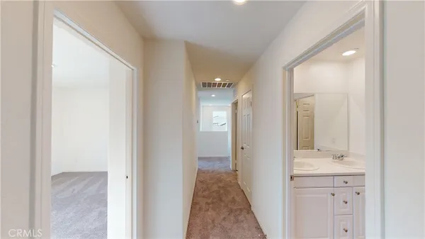 a bathroom with a bathtub shower sink vanity and mirror