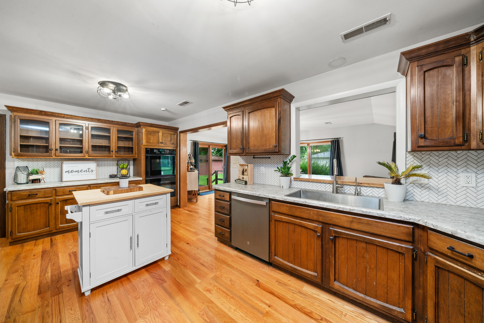 1102 Vale Street Sandwich, IL 60548 - Photo 14 of 44 a large kitchen with stainless steel appliances granite countertop a lot of counter space and wooden floors
