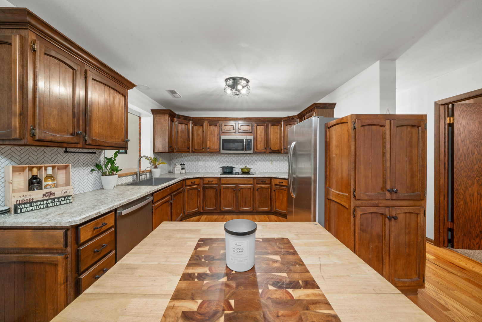 1102 Vale Street Sandwich, IL 60548 - Photo 10 of 44 a kitchen with stainless steel appliances granite countertop a refrigerator a sink and wooden cabinets