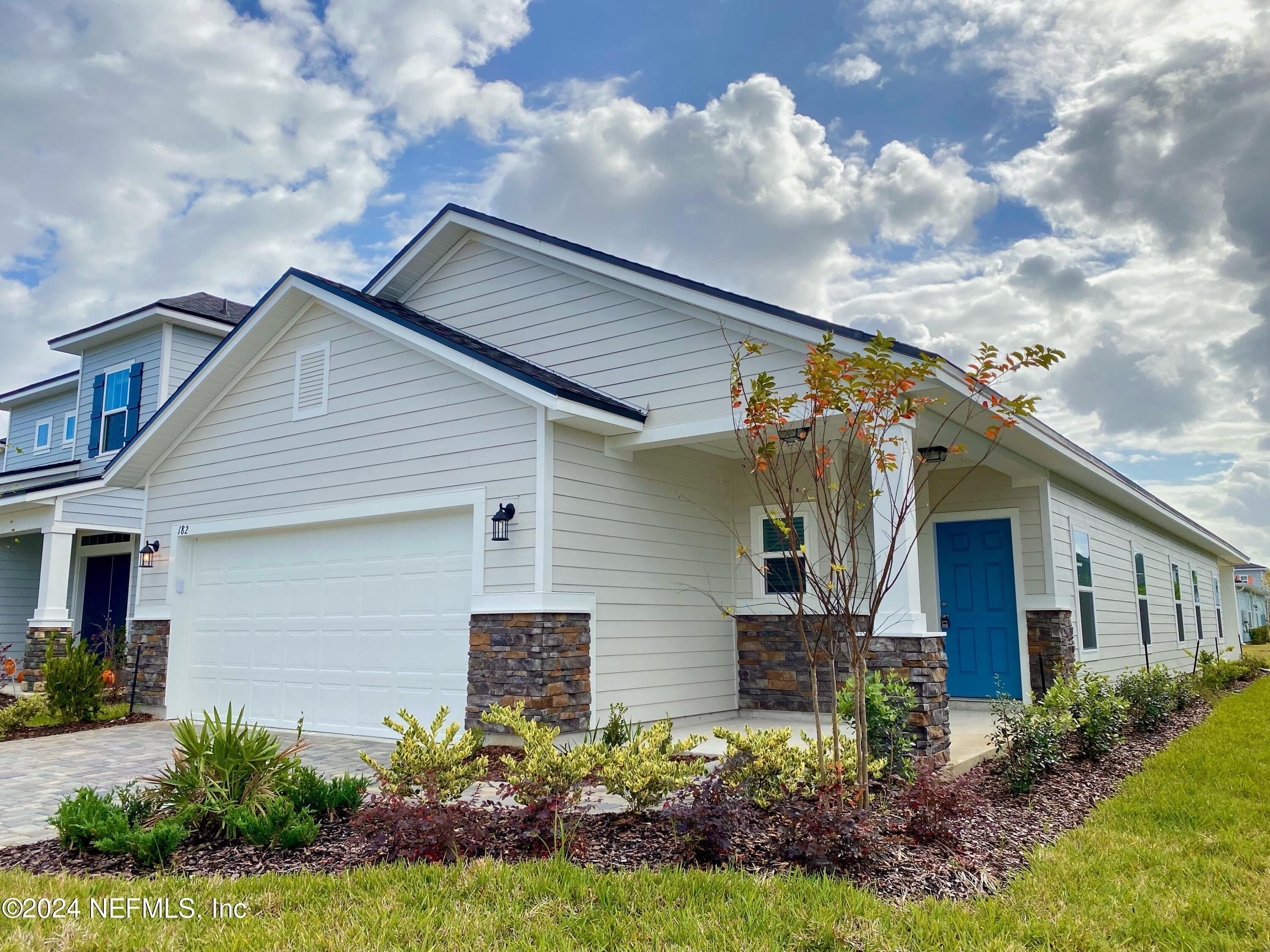 182 Holly Forest Drive St. Augustine, FL 32092 - Photo 1 of 29 a front view of house with a garden