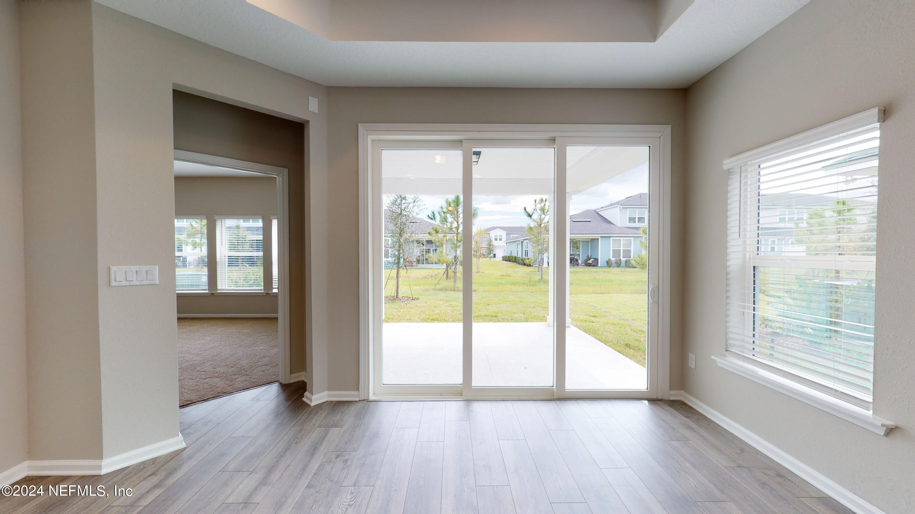 182 Holly Forest Drive St. Augustine, FL 32092 - Photo 18 of 29 a view of an empty room with wooden floor and a window