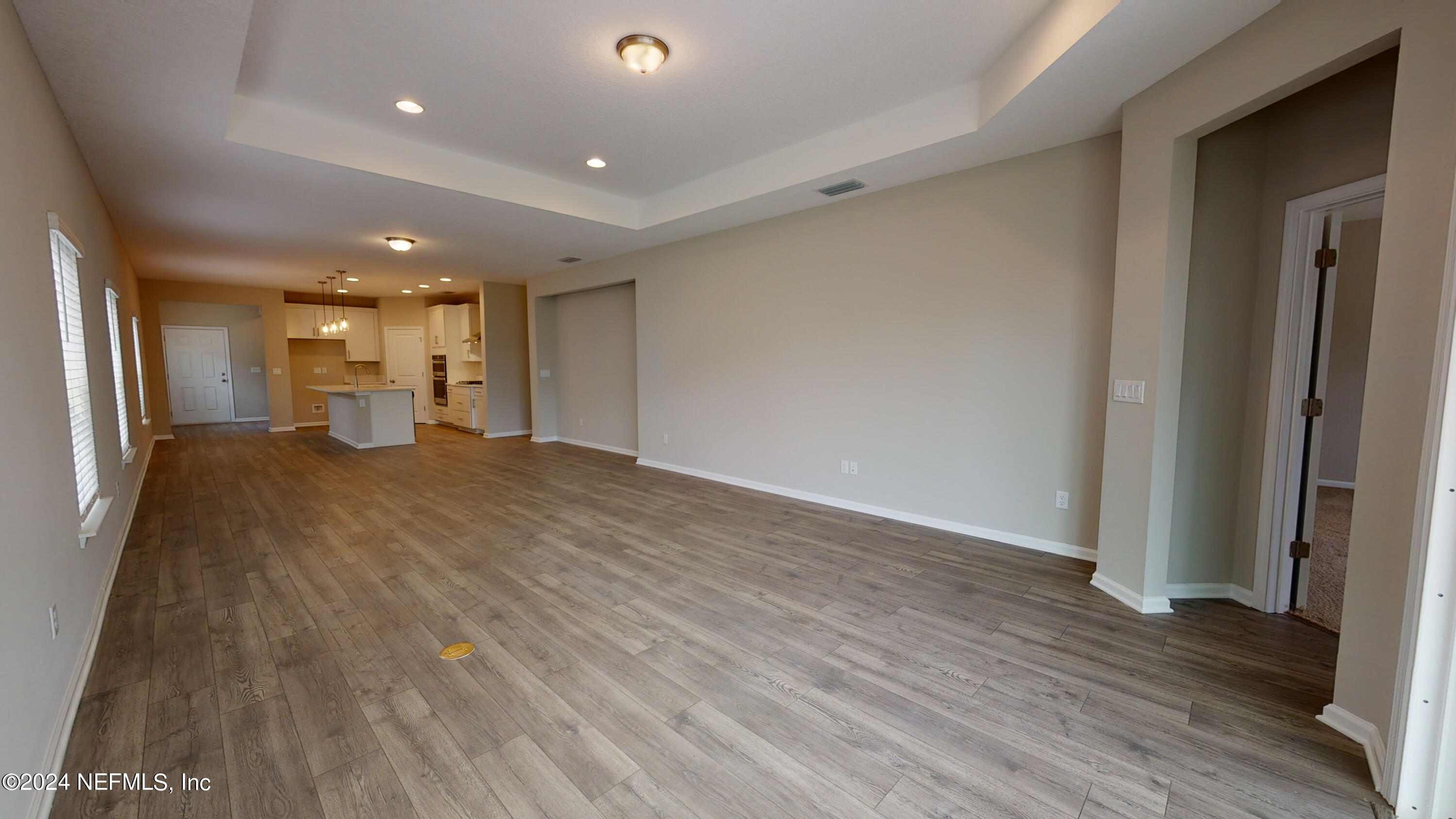 182 Holly Forest Drive St. Augustine, FL 32092 - Photo 19 of 29 a view of a big room with wooden floor and windows