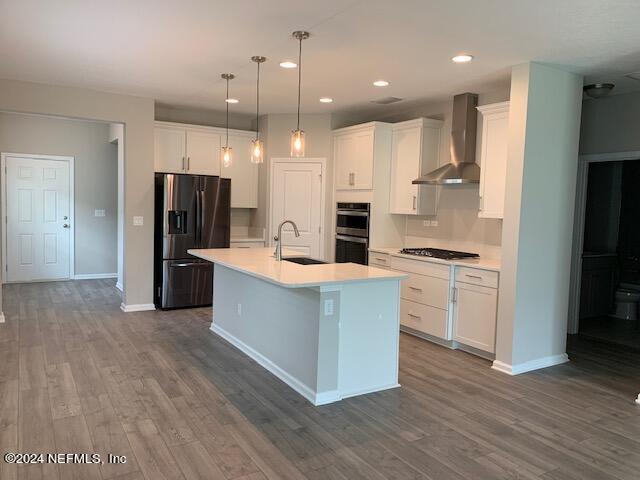 182 Holly Forest Drive St. Augustine, FL 32092 - Photo 10 of 29 a large kitchen with stainless steel appliances kitchen island a stove a refrigerator a sink and a oven with wooden floor