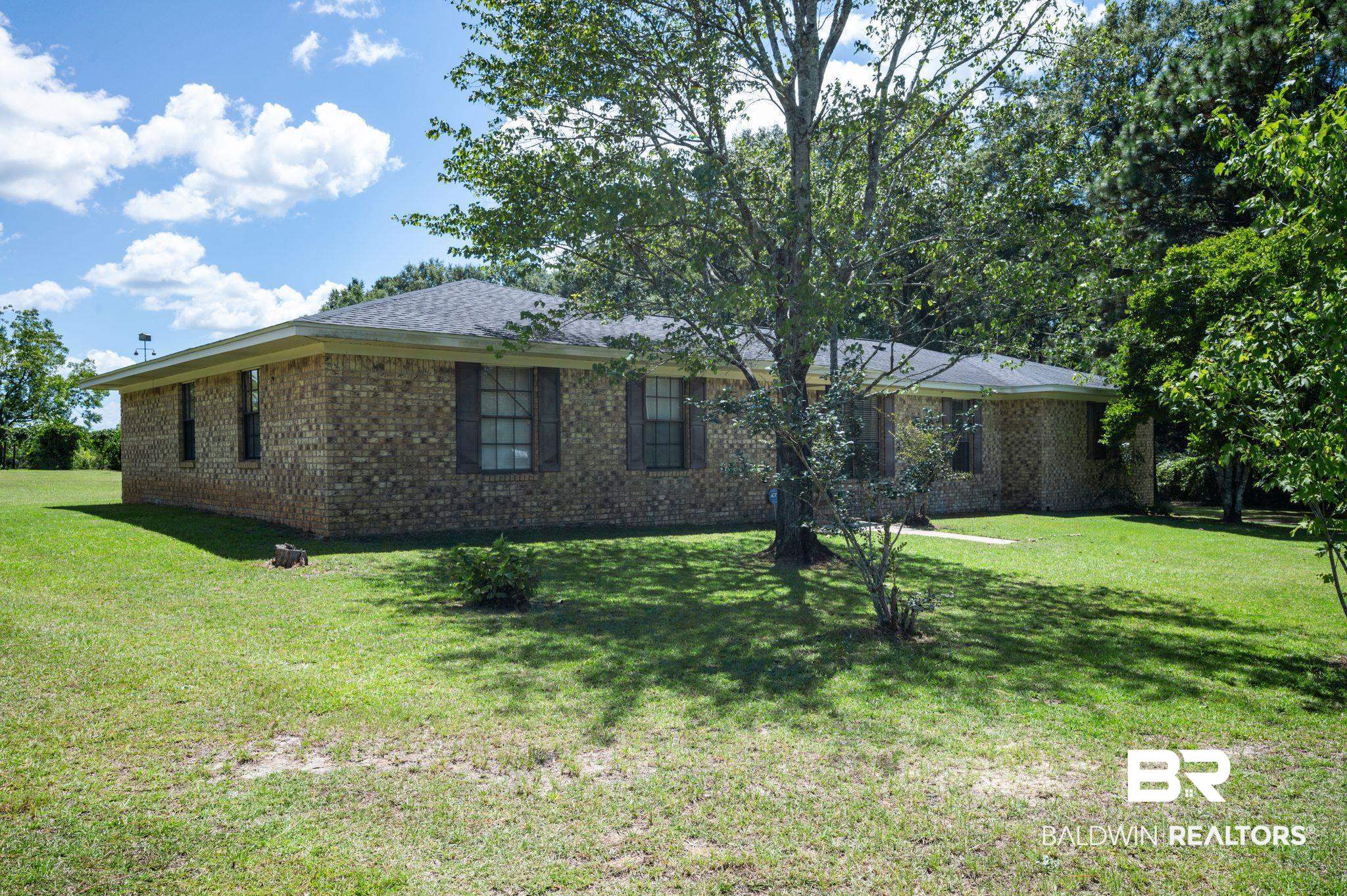 15880 Pine Grove Rd Extension West Bay Minette, AL 36507 - Photo 3 of 44 View of home's exterior featuring a yard