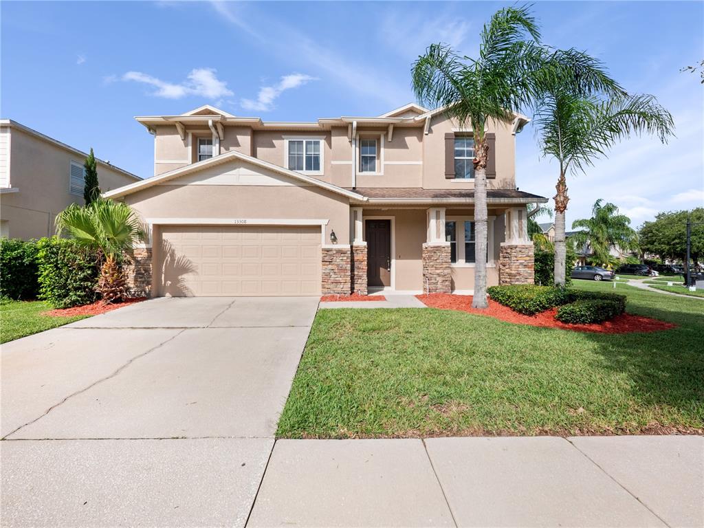 13308 Sproston Point Orlando, FL 32832 - Photo 1 of 1 a front view of a house with garden