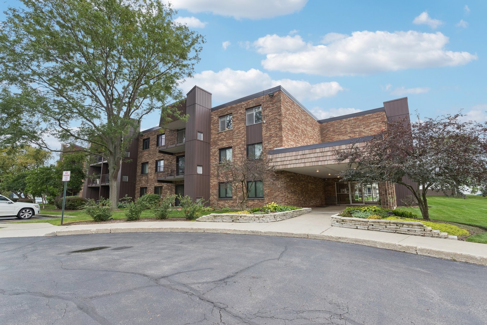 522 East Algonquin Road, Unit 201 Schaumburg, IL 60173 - Photo 1 of 27 a tall building with trees in front of it