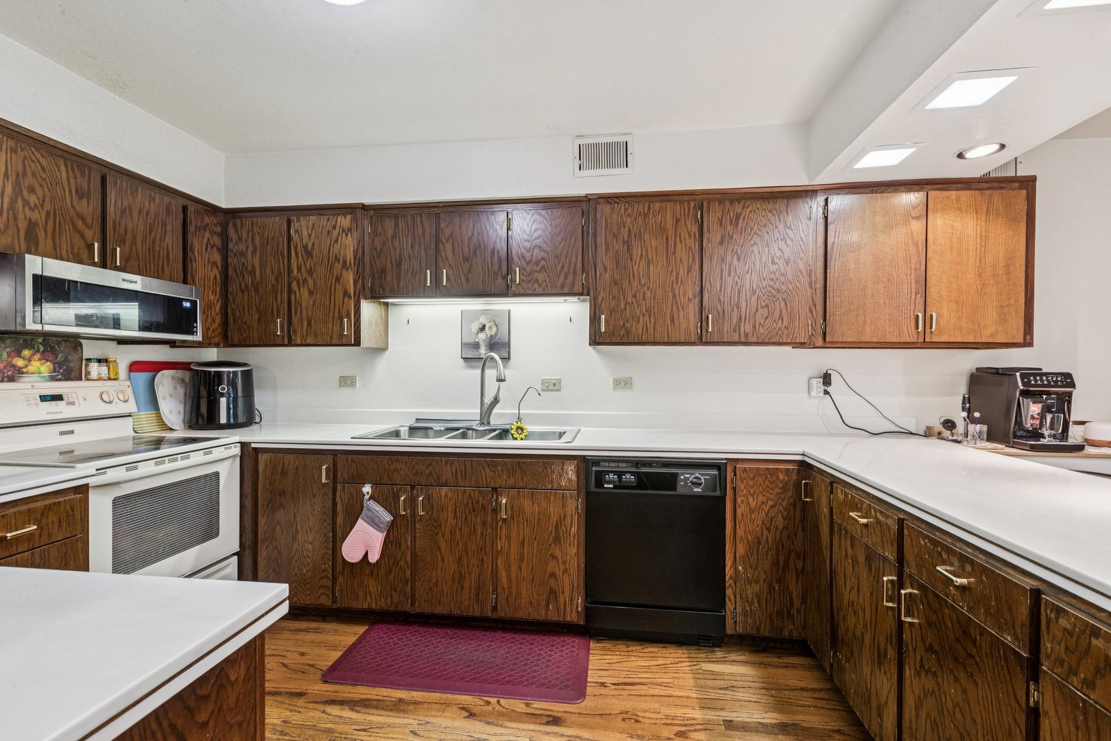 522 East Algonquin Road, Unit 201 Schaumburg, IL 60173 - Photo 12 of 27 a kitchen with stainless steel appliances granite countertop a sink stove and refrigerator