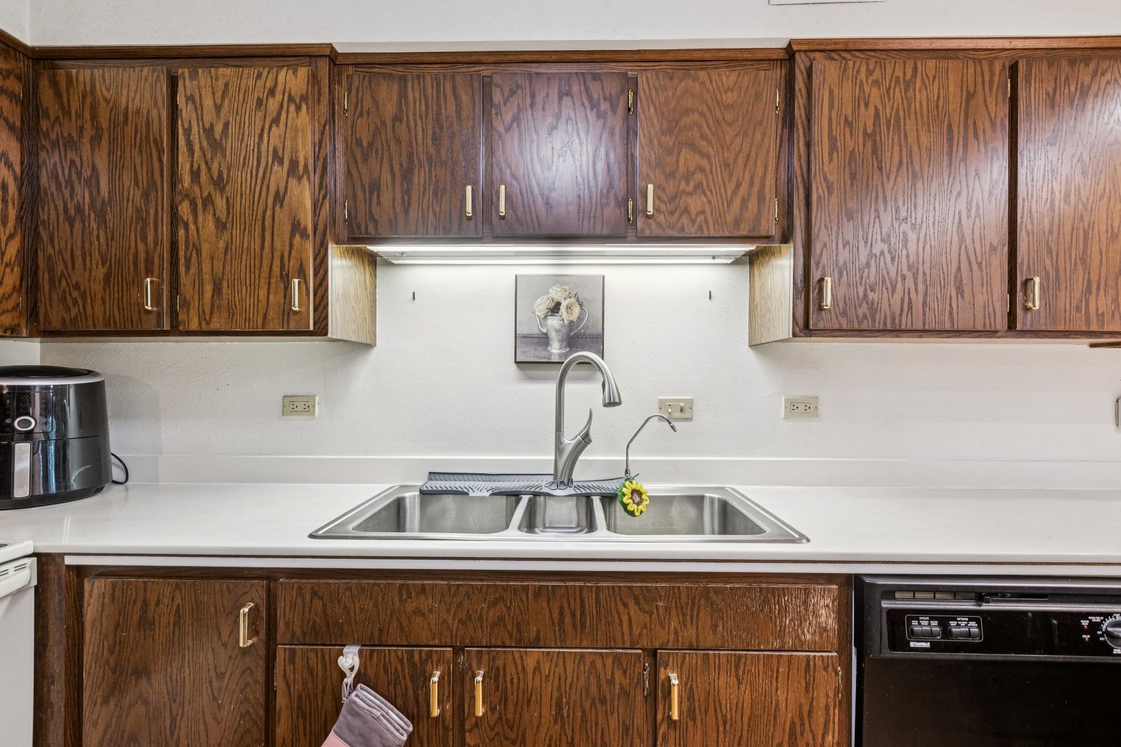 522 East Algonquin Road, Unit 201 Schaumburg, IL 60173 - Photo 13 of 27 a kitchen with kitchen island a sink and wooden cabinets