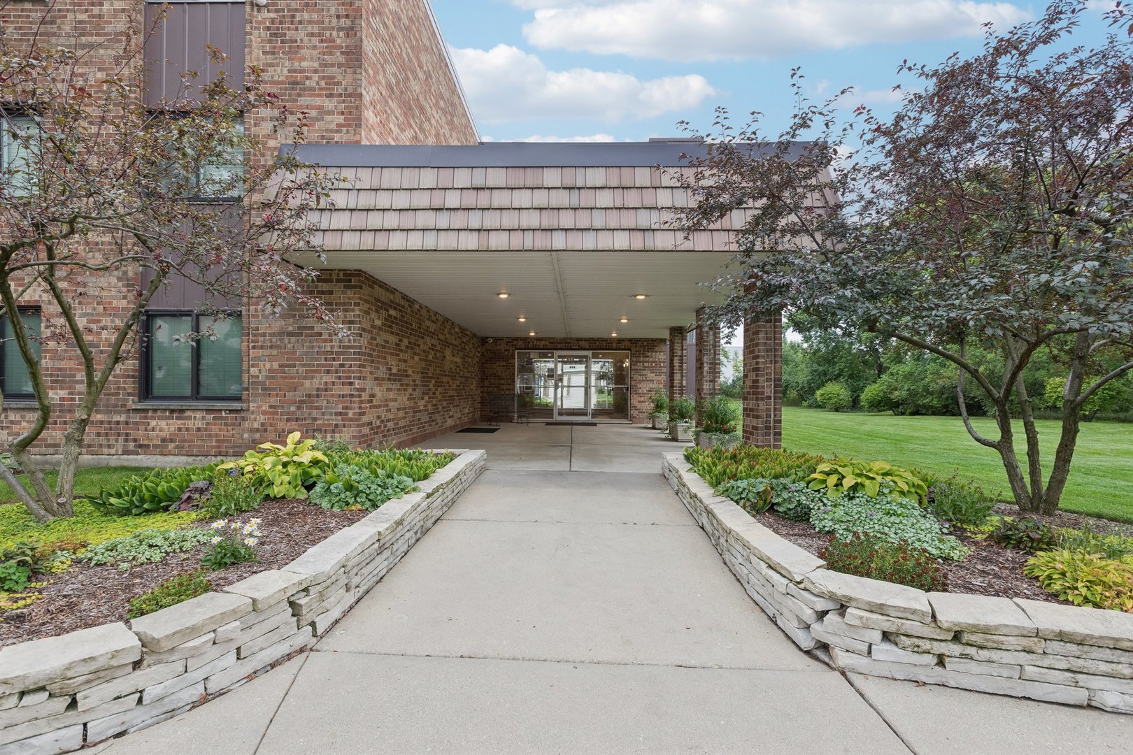 522 East Algonquin Road, Unit 201 Schaumburg, IL 60173 - Photo 2 of 27 a view of a building with a yard