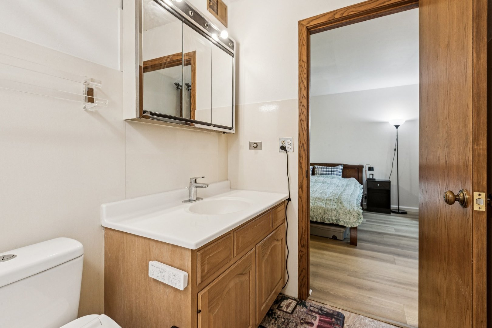 522 East Algonquin Road, Unit 201 Schaumburg, IL 60173 - Photo 24 of 27 a en suite bathroom with a sink and a mirror