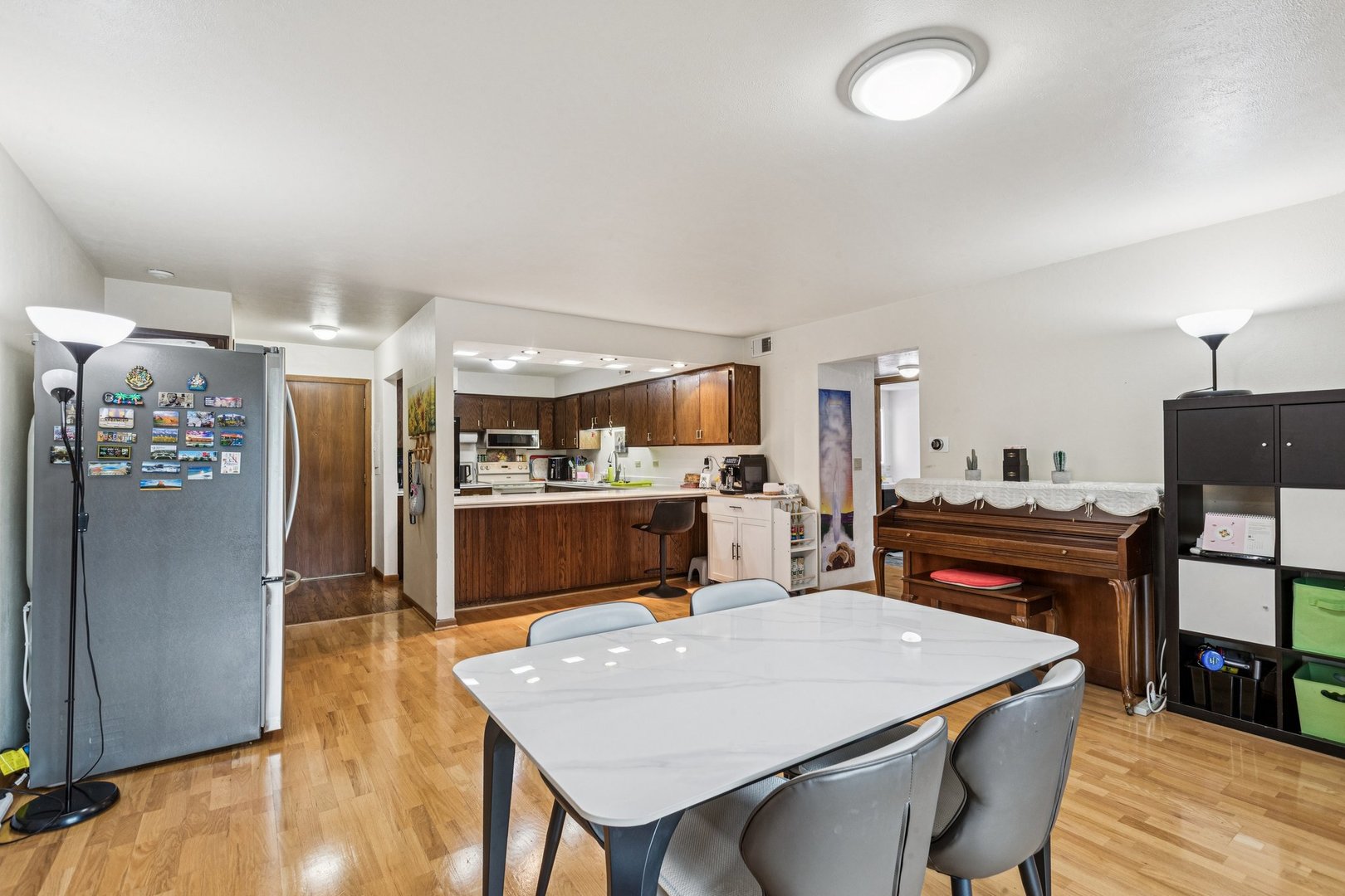 522 East Algonquin Road, Unit 201 Schaumburg, IL 60173 - Photo 8 of 27 a dining hall with stainless steel appliances kitchen island granite countertop a refrigerator a stove a microwave oven with white cabinets and wooden floor