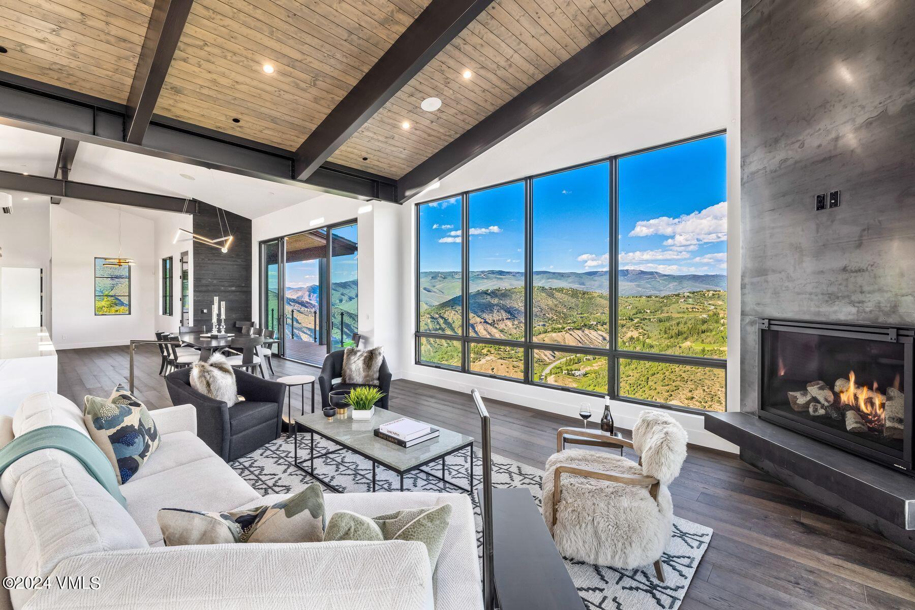 636 Saddle Ridge Loop Edwards, CO 81632 - Photo 11 of 46 a living room with fireplace furniture large window and wooden floor