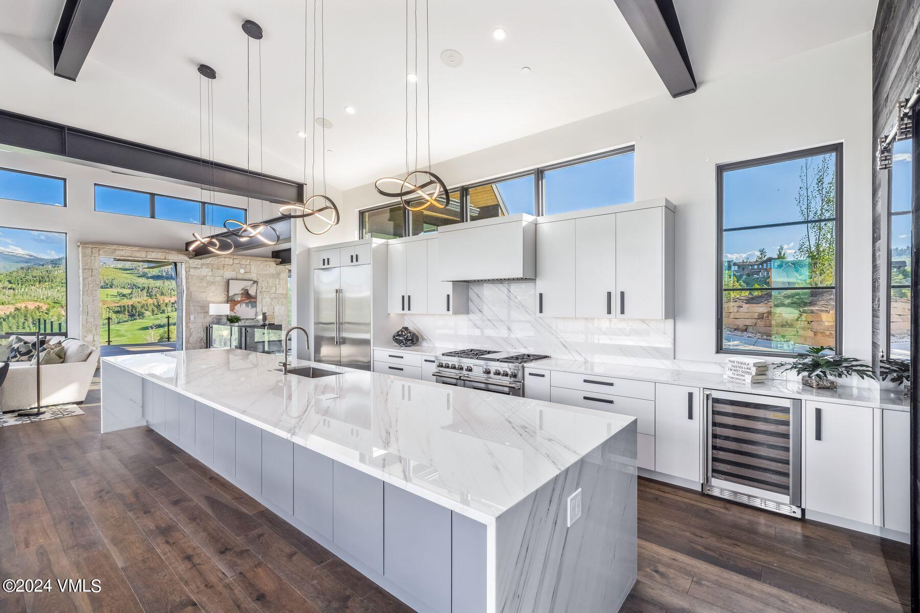 636 Saddle Ridge Loop Edwards, CO 81632 - Photo 20 of 46 a large kitchen with kitchen island a large counter space a sink appliances and a large window