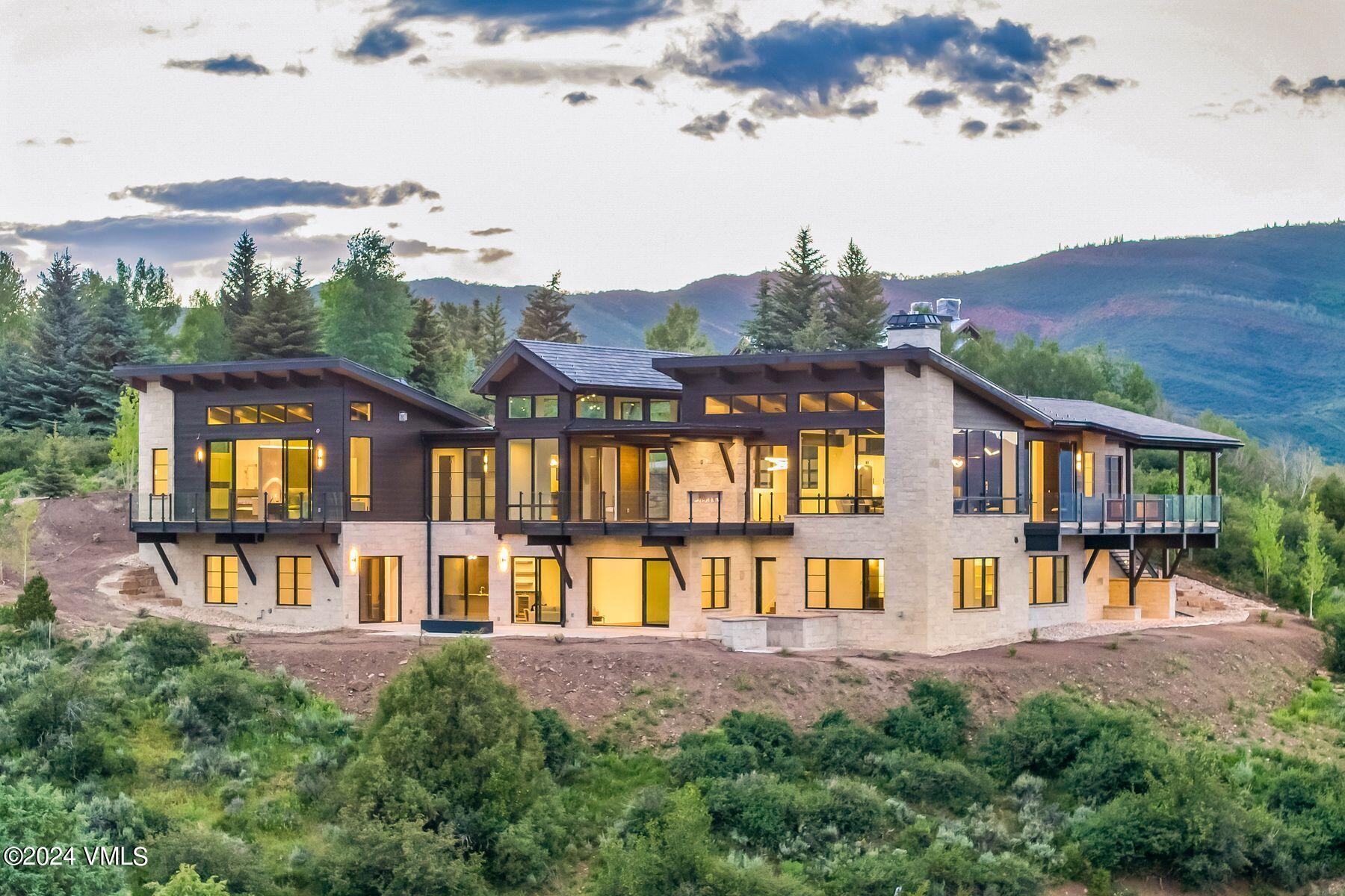 636 Saddle Ridge Loop Edwards, CO 81632 - Photo 2 of 46 a view of a big house with a big yard and large trees