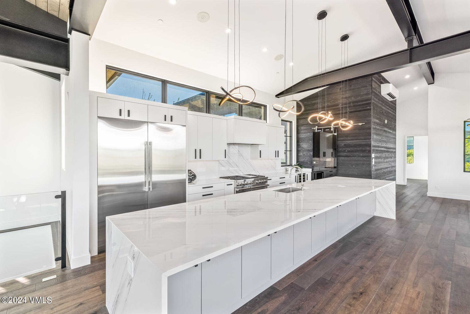 636 Saddle Ridge Loop Edwards, CO 81632 - Photo 22 of 46 a large white kitchen with a white countertops a sink and a refrigerator