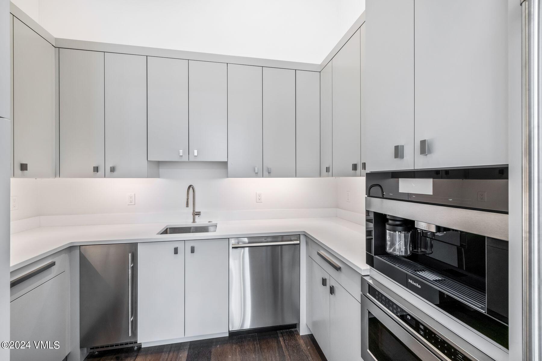 636 Saddle Ridge Loop Edwards, CO 81632 - Photo 23 of 46 a kitchen with granite countertop white cabinets and stainless steel appliances