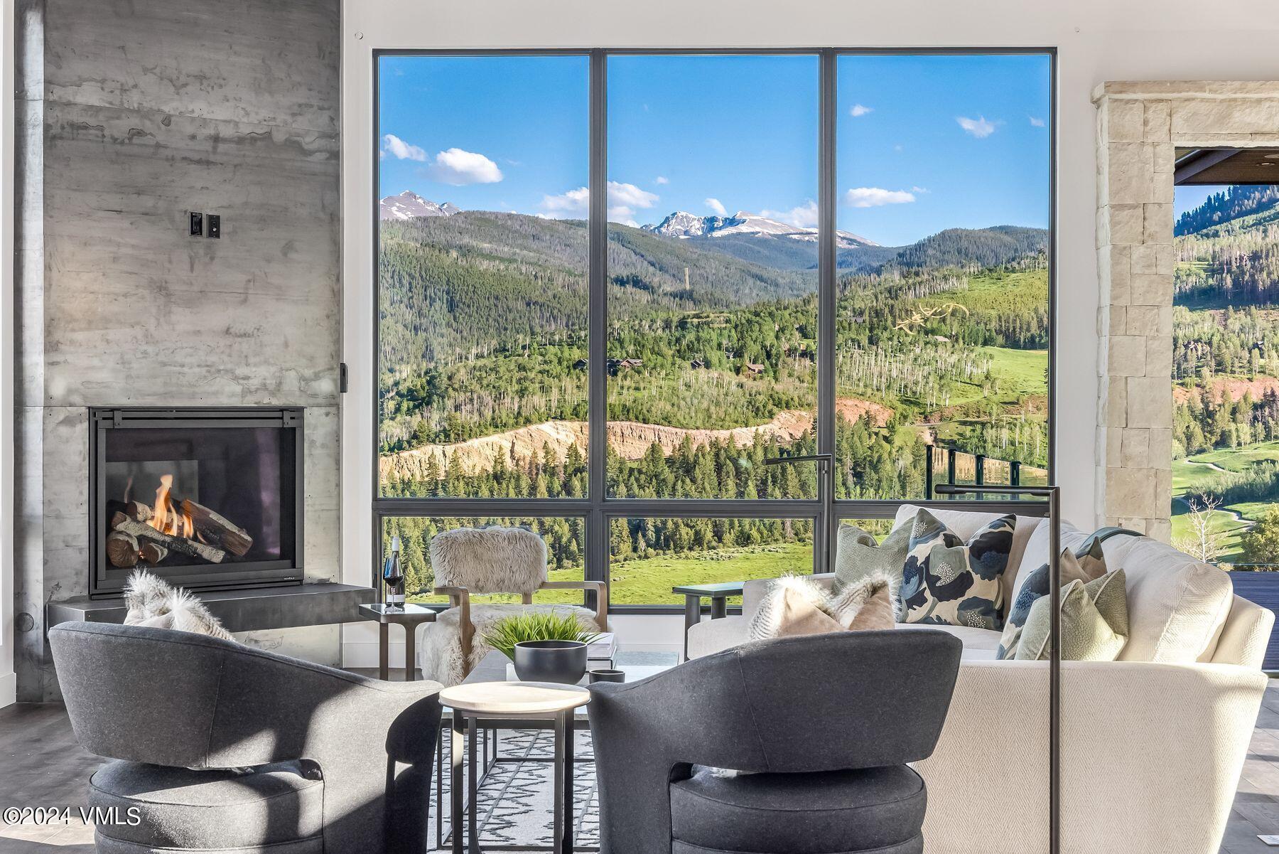 636 Saddle Ridge Loop Edwards, CO 81632 - Photo 7 of 46 a living room with fireplace furniture and a large window