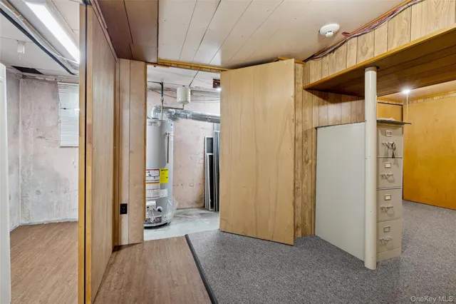 a view of a hallway with wooden shelves
