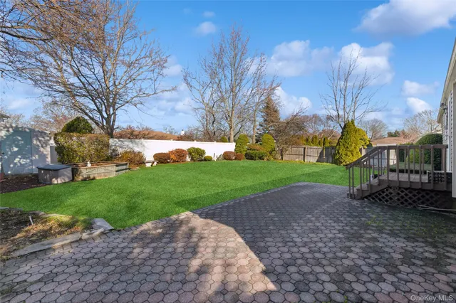 a front view of a house with a yard and outdoor seating