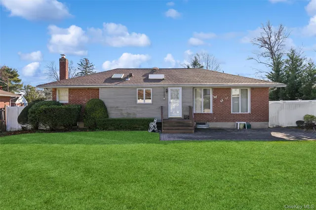 a front view of a house with a garden and yard