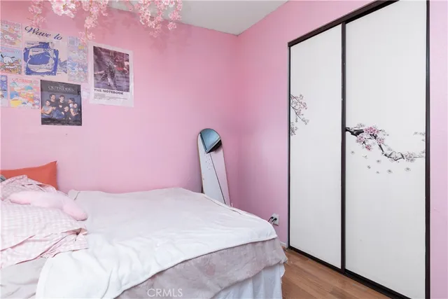 a bedroom with a bed and a mirror