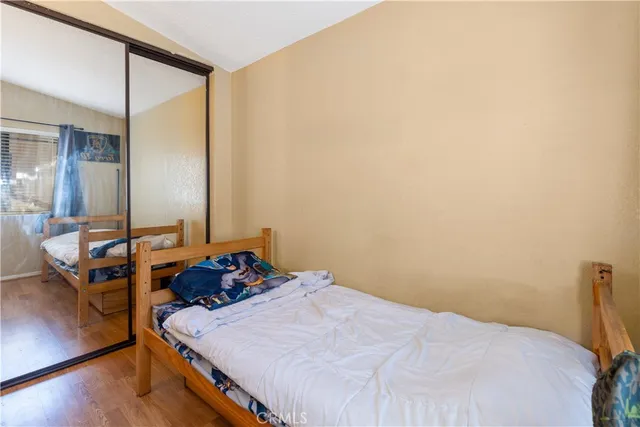 a bedroom with a bed and wooden floor