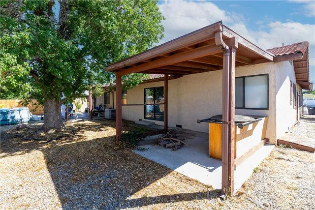 a view of a backyard with tree