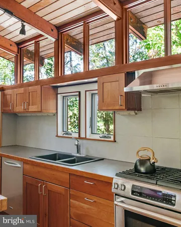 a kitchen that has a stove and a window