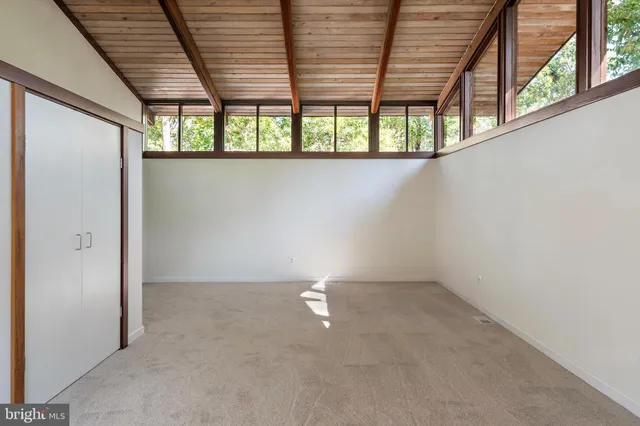 an empty room with large windows