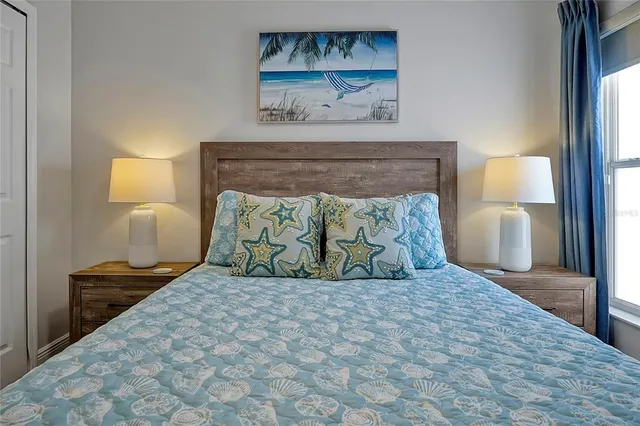 a bedroom with a bed and a painting on the wall