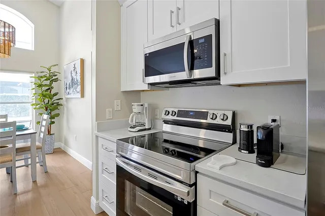 a view of a dining room with furniture and a potted plant