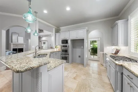 a kitchen with granite countertop a stove oven and a refrigerator