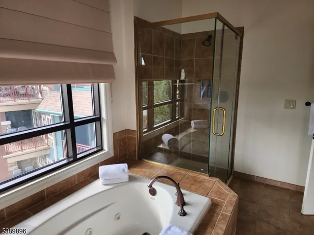 a bathroom with a tub and shower