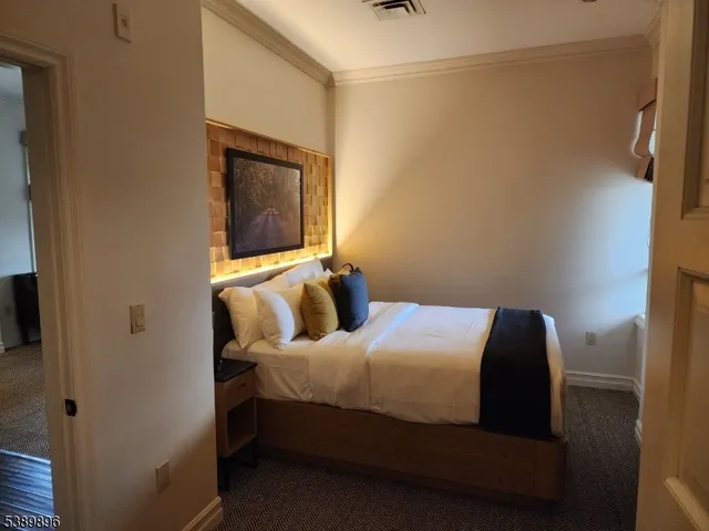 a bedroom with a bed and a mirror