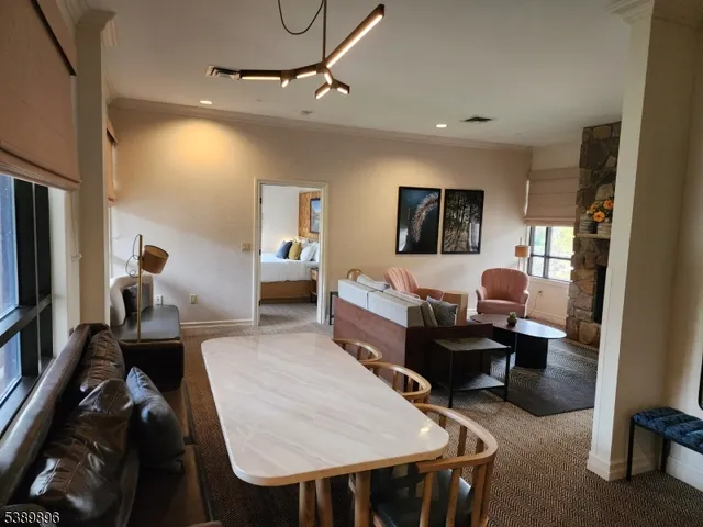 a living room with furniture a flat screen tv and a window