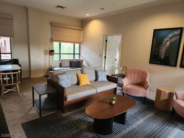 a living room with furniture a rug and a large window