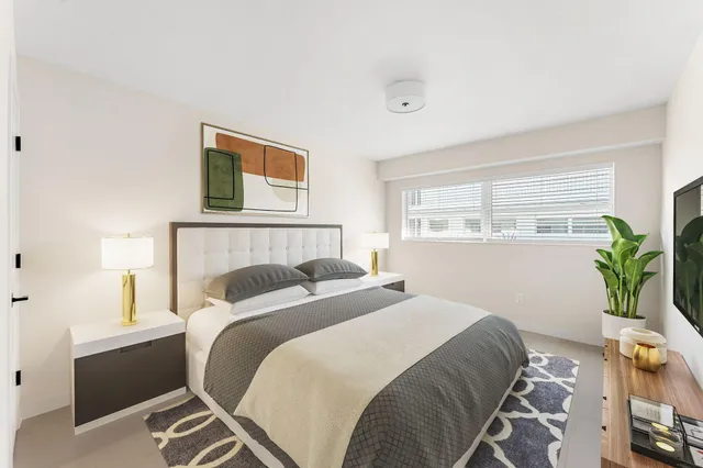 a bedroom with a bed and a window