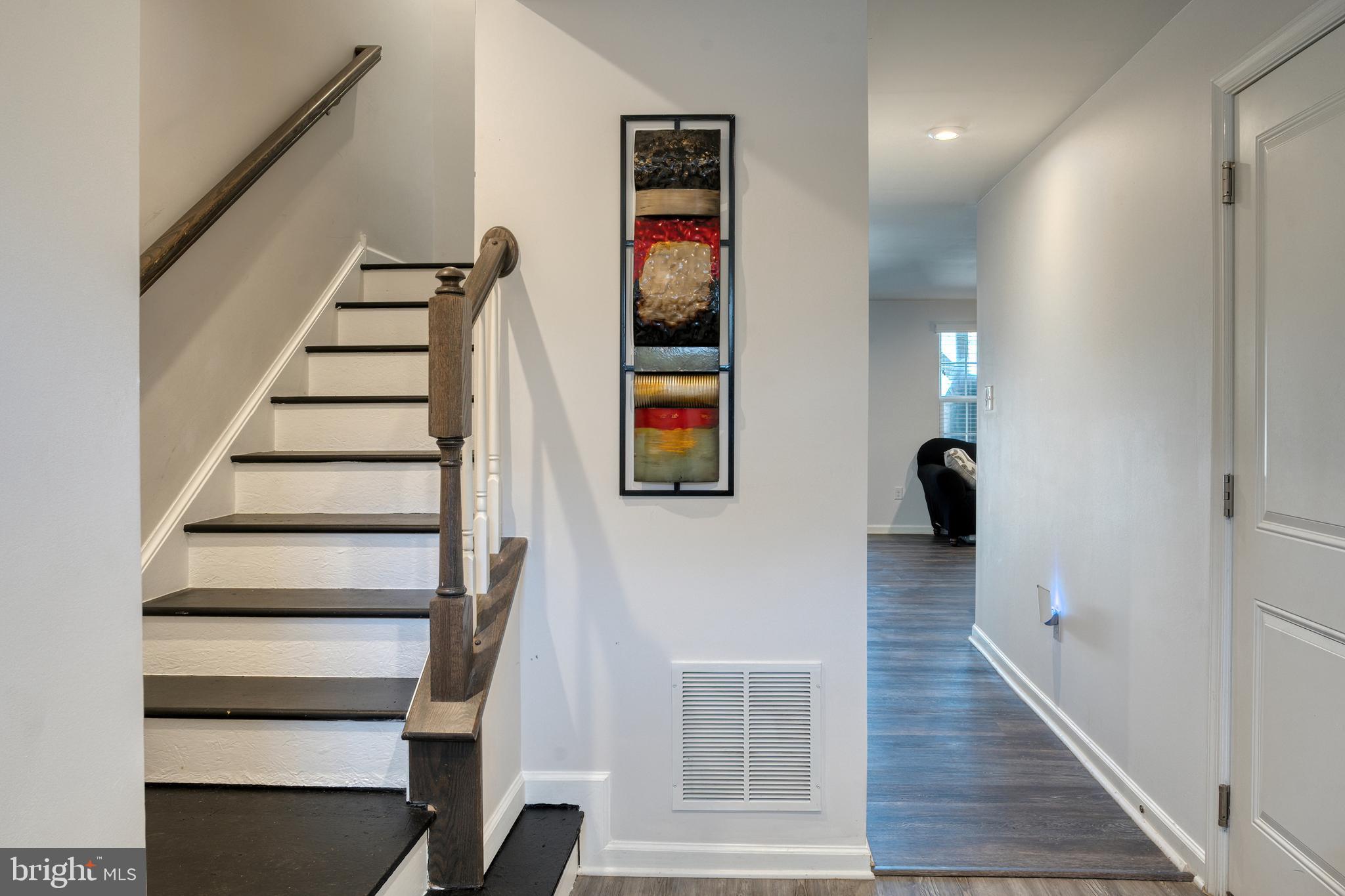 133 Spire Place Sewell, NJ 08080 - Photo 11 of 49 a view of a hallway with wooden floor and stairs