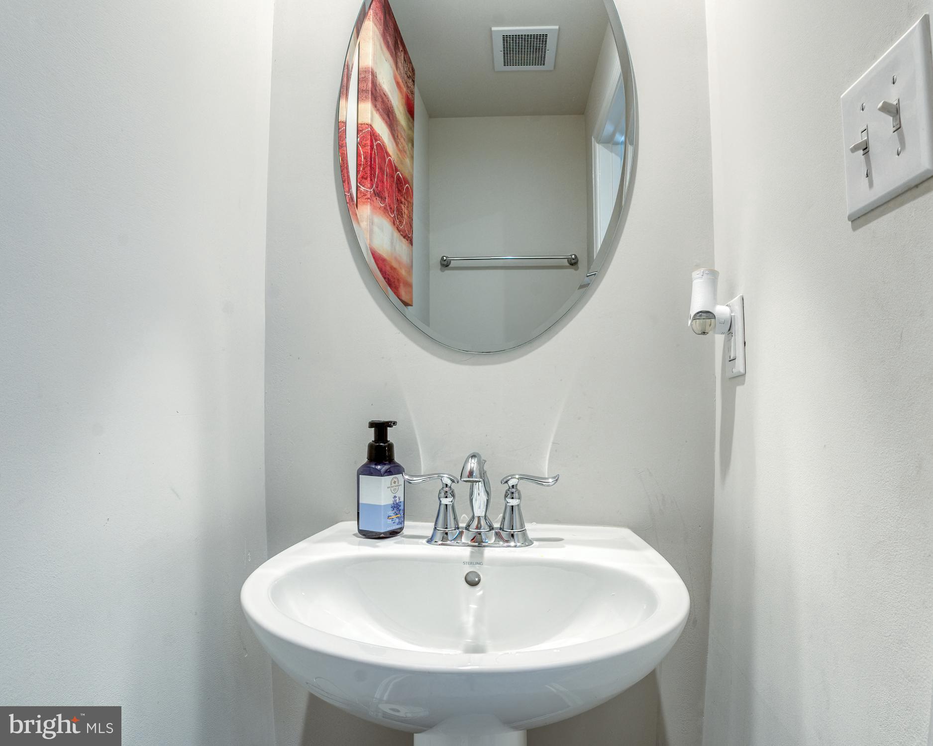 133 Spire Place Sewell, NJ 08080 - Photo 17 of 49 a bathroom with a mirror and a sink