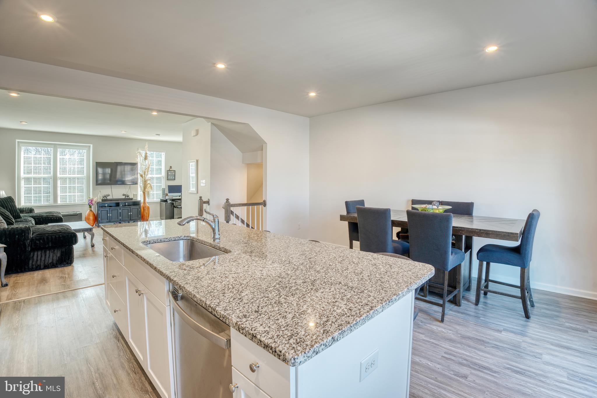 133 Spire Place Sewell, NJ 08080 - Photo 25 of 49 a kitchen with granite countertop kitchen island a sink table and chairs