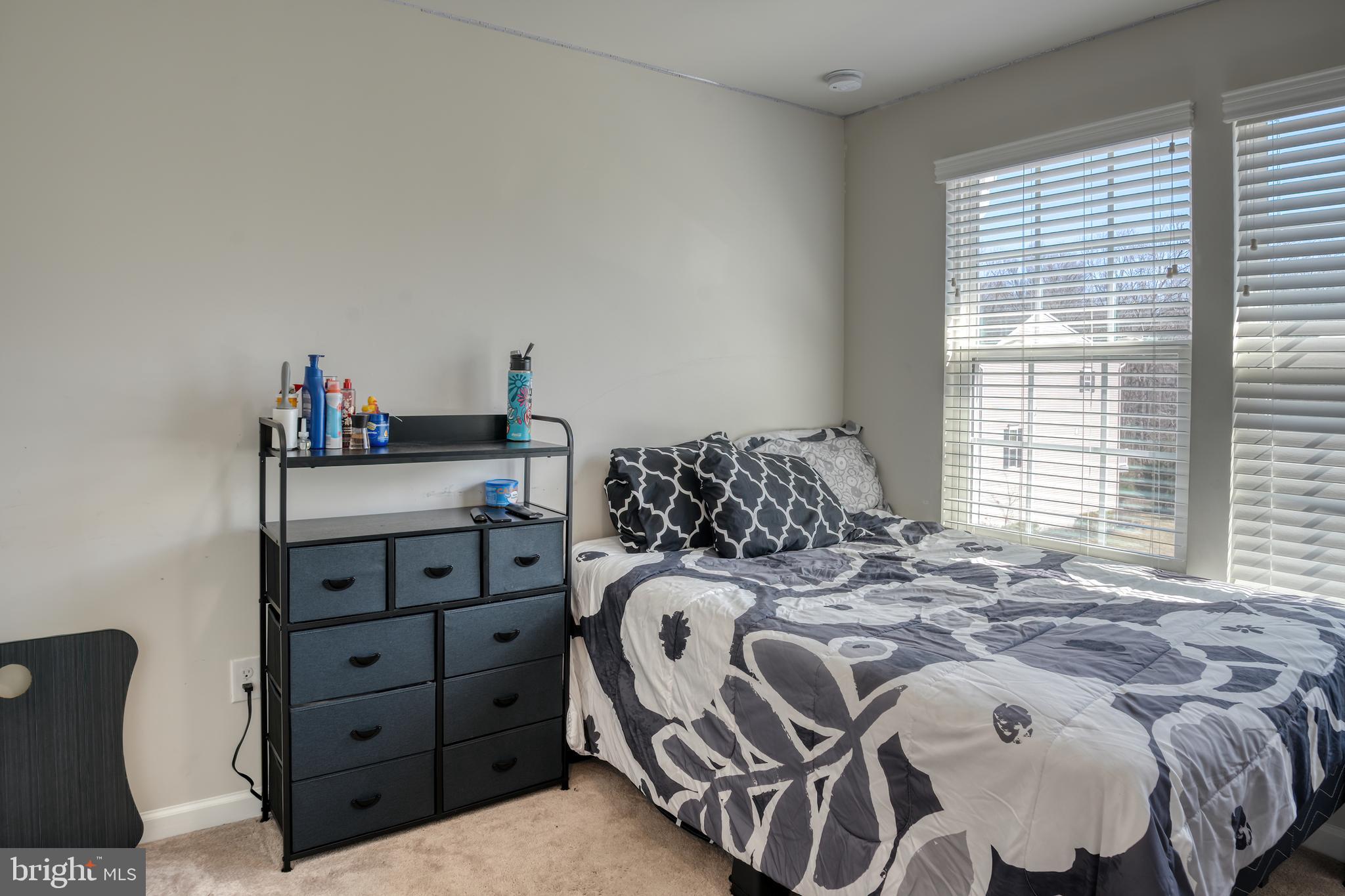 133 Spire Place Sewell, NJ 08080 - Photo 39 of 49 a bed sitting in a bedroom next to a window and dresser