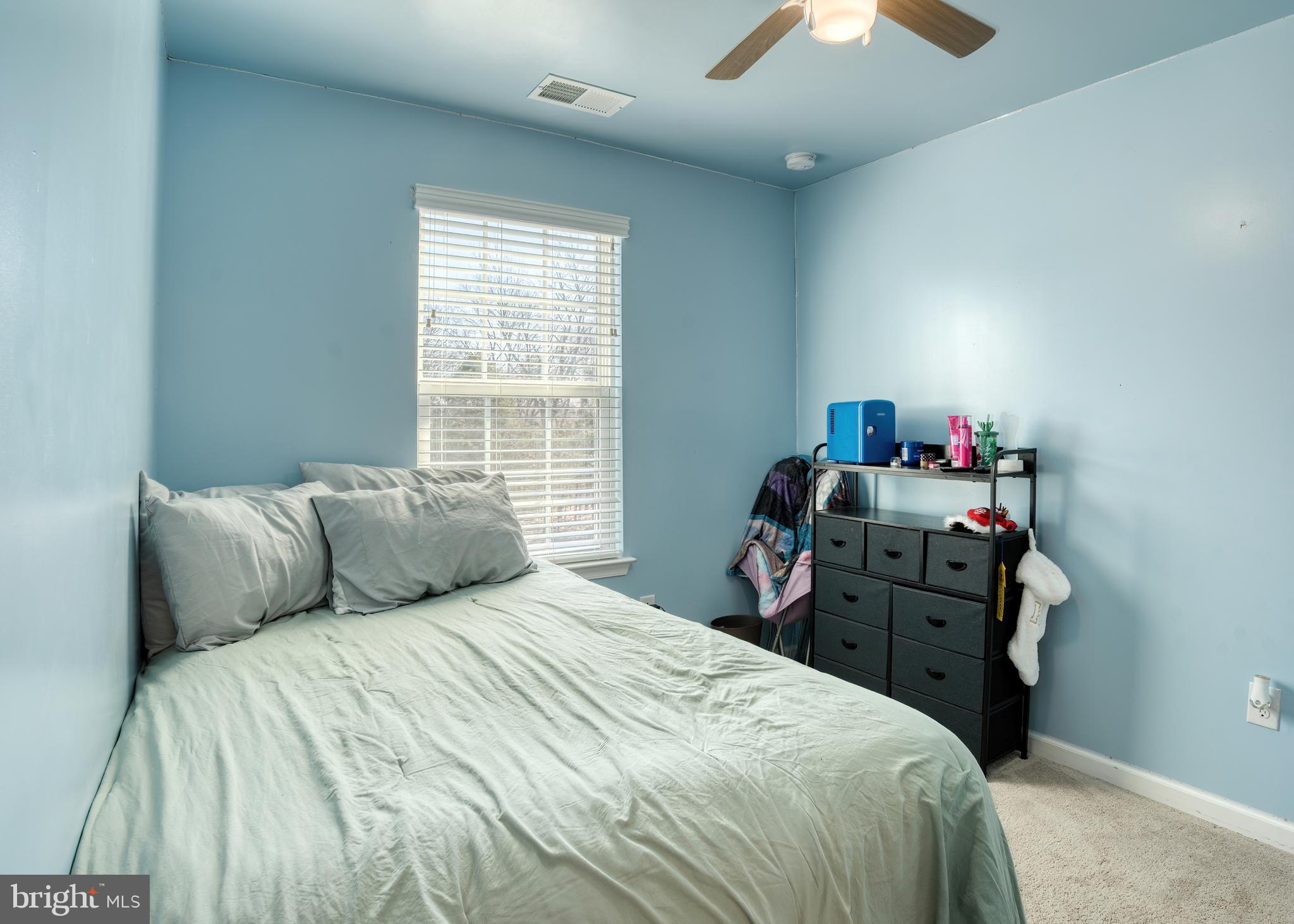 133 Spire Place Sewell, NJ 08080 - Photo 41 of 49 a bedroom with a bed and a chandelier
