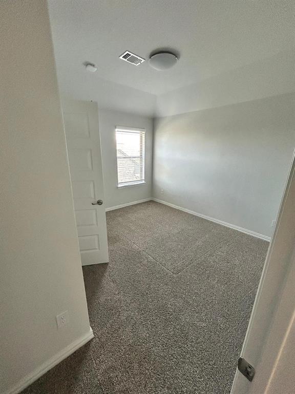 1704 Dunbrook Road McKinney, TX 75071 - Photo 15 of 17 Spare room with baseboards and dark colored carpet